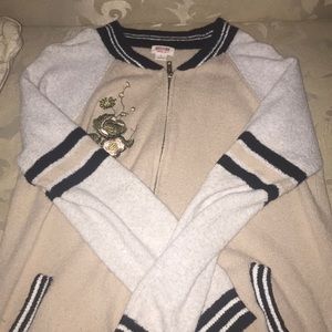 cream colored jacket with a rose on it